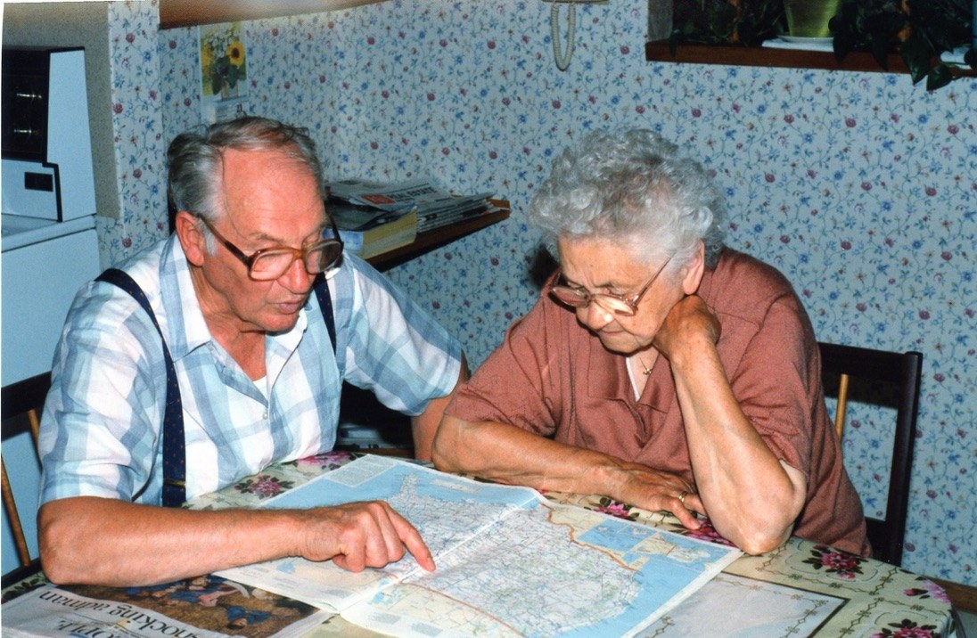 Opa sharing a paper map at the dining room table